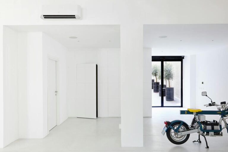 Bright minimalist room featuring a modern motorbike and stylish decor elements.