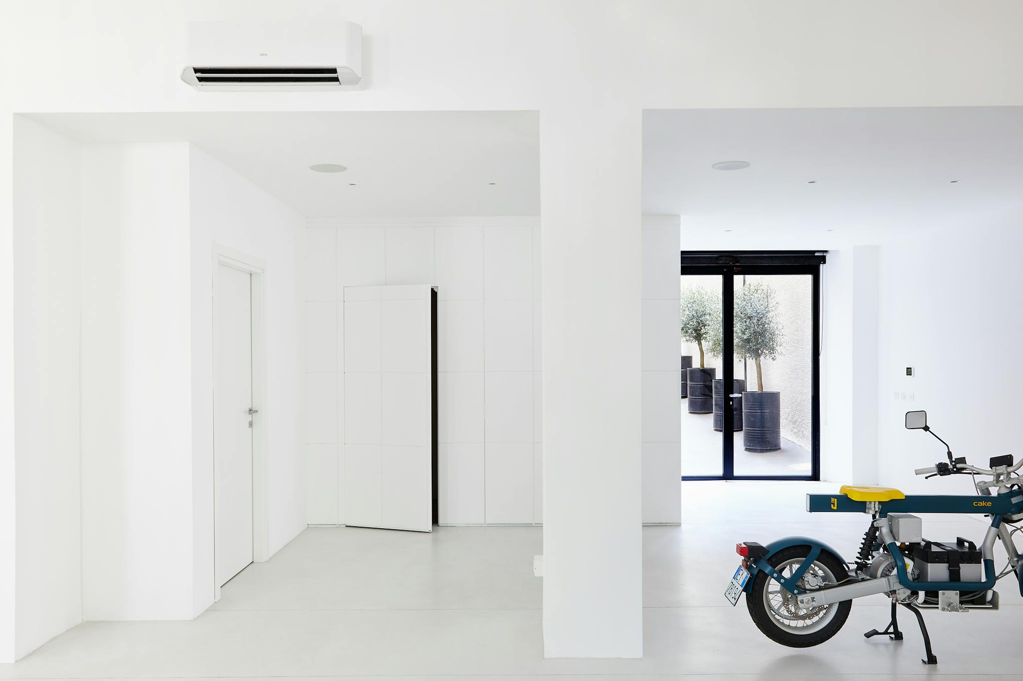 Bright minimalist room featuring a modern motorbike and stylish decor elements.