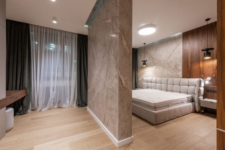 Interior of modern bright bedroom with bed and bedside tables under pendant lamps in evening