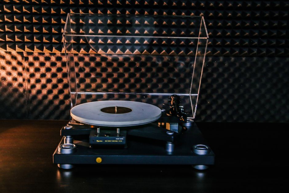 A classic turntable sits in a soundproofed room, ideal for audiophiles.