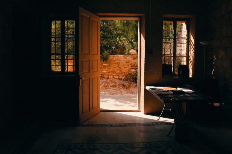 Warm sunlight streams through an open door in a traditional home interior in Amman, Jordan.